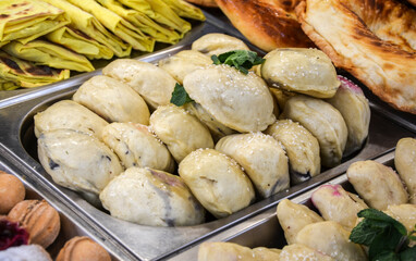 Fresh and delicious dumplings displayed in a buffet setting, complemented by various baked goods...