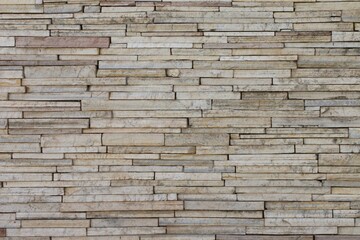A wall made of stone with a lot of cracks and holes