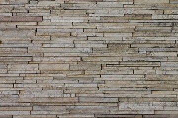 A wall made of stone with a lot of small squares