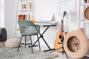 Interior of living room with synthesizer, guitar and shelf units