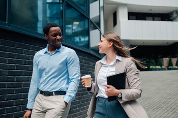 Business people walking and talking outside office building