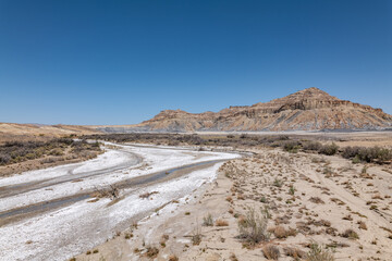 Salt deposits in a dry river bed. Alluvium（Gravel, sand, silt, and clay in poorly to moderately...