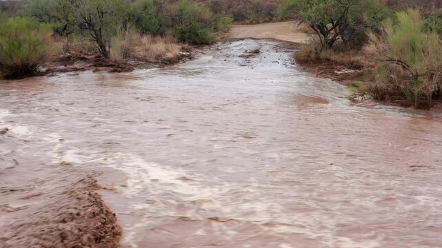 Aerial drone footage crossing over a road flooded by an Arizona monsoon flash flood. 