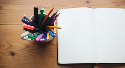 Obraz premium An open notebook with pen and pencils. 