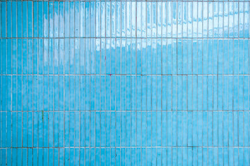 harmonic pattern of small wall tiles glazed in light blue