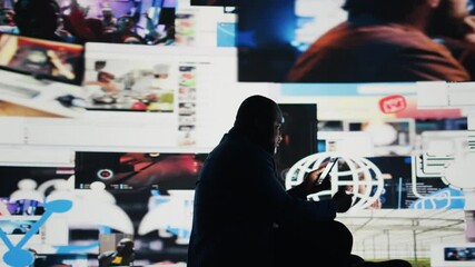 Black man holding a device portraying the harmful effects of excessive social media interaction, social anxiety and isolation in the digital world. Showcases manipulation and paranoia. Camera A.