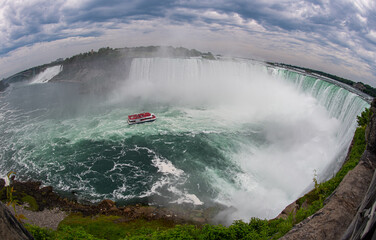 Unusual aerial fisheye view of Horseshoe Falls including Niagara City cruises boat with passengers...