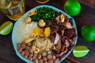 The best traditional Brazilian feijoada completely served in the most authentic style accompanied by the irresistible and iconic cachaça caipirinha