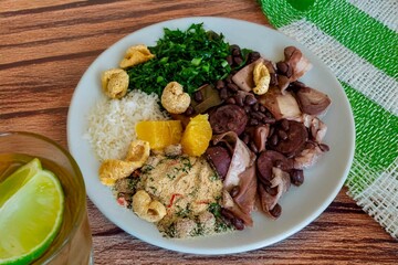 The best traditional Brazilian feijoada completely served in the most authentic style accompanied by the irresistible and iconic cachaça caipirinha