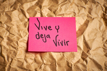 Spanish phrase about tolerance and freedom handwritten on paper
