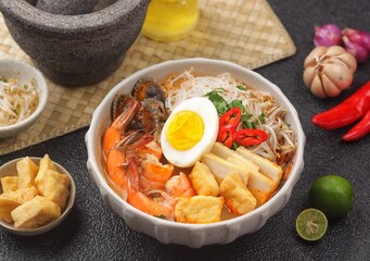 Laksa is a spicy noodle soup popular in the Peranakan cuisine of Southeast Asia. Laksa consists of thick wheat noodles or rice vermicelli with chicken, prawn or fish, served in spicy soup.