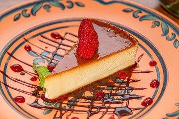 Napolitan Flan with Strawberry on Clay Plate in Colonial Restaurant