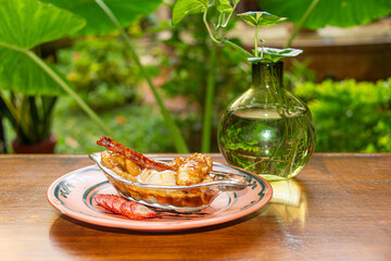 Flambéed Banana with Vanilla Ice Cream on Glass Plate in Colonial Restaurant