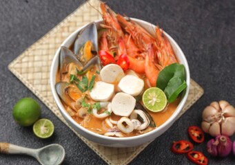 Traditional Thai soup Tom Yum kung with seafood, fish ball,coconut milk and chili pepper