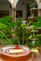 Napolitan Flan with Strawberry on Clay Plate in Colonial Restaurant