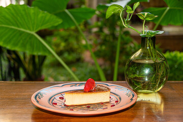Napolitan Flan with Strawberry on Clay Plate in Colonial Restaurant