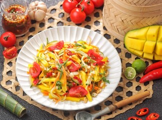 Spicy Thai Mango Salad featuring fresh flavors of cucumber, carrot and cilantro spicy, sweet and savory dressing.