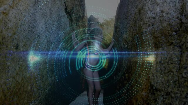 Two sisters emerging from beach crevice and activating tech rings wrapping around floaties