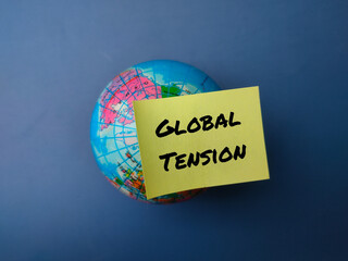 Top view globe and sticky note with the word GLOBAL TENSION on a blue background