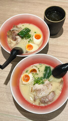 Japanese soup ramen with meat broth asian noodles seaweed sliced pork eggs and ginger on dark...