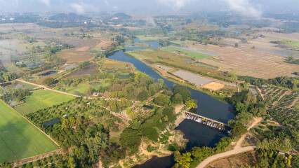 Aerial view of river flowing through abundance landscape in rural area of Chiang Rai province of Thailand.
