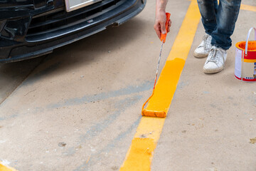 The workers are painting new parking lines.