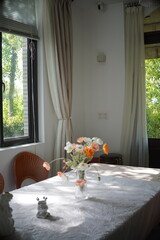Flowers on a Table by Window Overlooking Forest Countryside