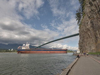 Cargo ship below lions gate bridge in Vancouver. Stanley park