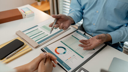 the company's auditing staff is checking the documents for accuracy in the office, businessman is...