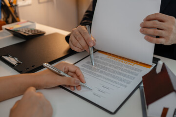 staff is explaining the information about the house lease contract documents to the buyer, the...