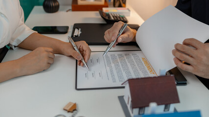 staff is explaining the information about the house lease contract documents to the buyer, the...