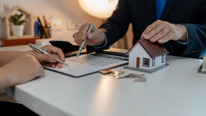 staff is explaining the information about the house lease contract documents to the buyer, the...