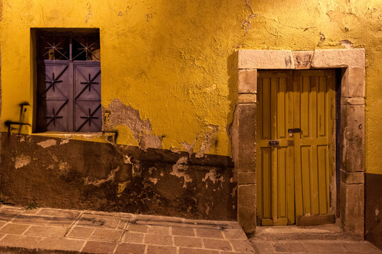 Locked Door and Barred Window at Night