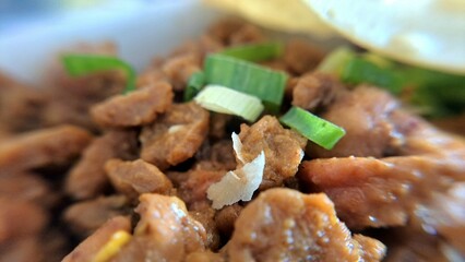 Mie Ayam Chicken Topping. Macro shot of flavorful diced chicken topping for Mie Ayam, Indonesian...