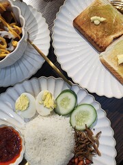 Traditional Malaysian Breakfast with Nasi Lemak, Toast, and Cheese Fries