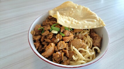 Indonesian Chicken Noodles. Delicious Mie Ayam, Indonesian chicken noodles with savory sauce, chicken pieces, and crispy wonton chips. A popular street food dish