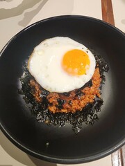 Kimchi Fried Rice Topped with Sunny Side Up Egg in Bowl