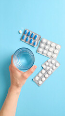 pills and capsules and glasses of drinking water
