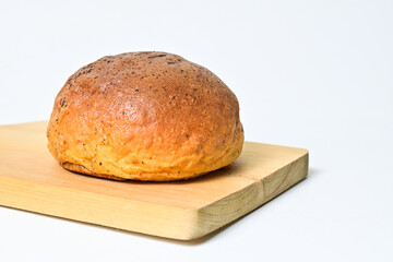 Close up view of choco bun on wooden cutting board isolated on white background. clipping path,...