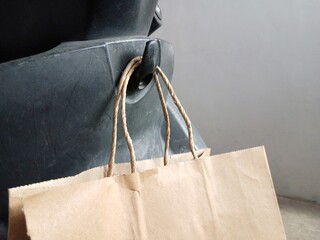 Paper shopping bags on motorcycle hook baggage.