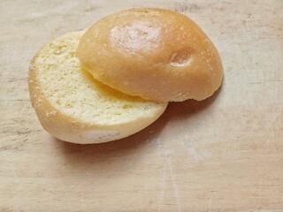 Dry burger patties on a wooden board. Bagel bread.