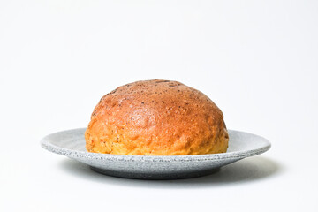 Side view of choco bun on little grey or gray plate isolated on white background. clipping path, baked, brown, close up.