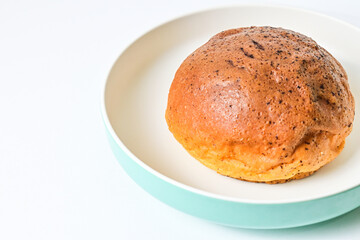 Close up view of choco bun on plate isolated on white background. clipping path, baked, brown. Half.