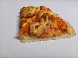 A slice of pizza topped with cheese and mushrooms on a white background. 