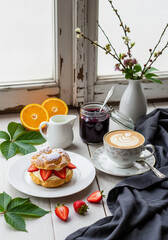 Cup coffee of latte art with Cream and strawberry puffs