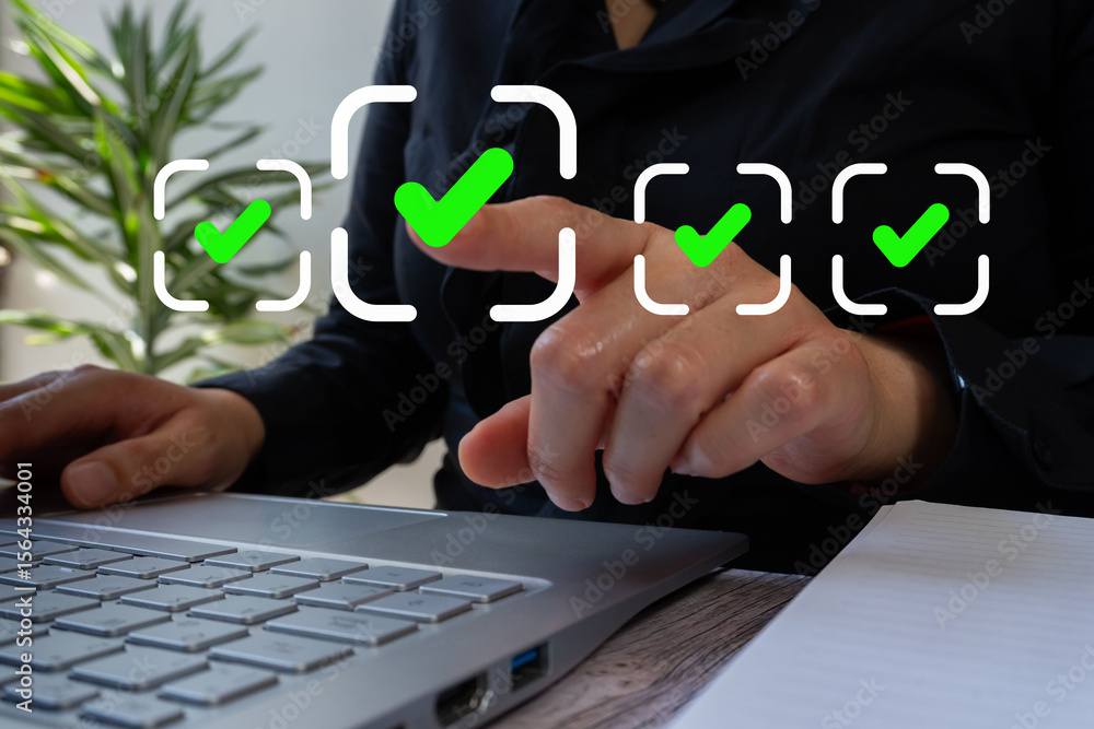 Poster businesswoman in front of a computer pointing at a check mark on a rectangle that stands out from ot