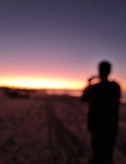 Fototapeta premium silhouette of a man taking a photo