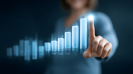 Woman interacting with a holographic bar graph with her finger on a dark blue background
