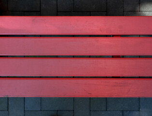 Modern Red Painted Wooden Bench with Stone Tiled Background