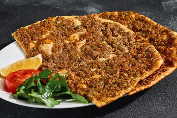 Lamadjo flatbread with ground beef, bright lighting, overhead plate arrangement